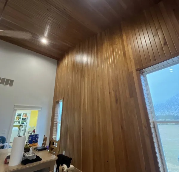 Finished wood paneling room by Peak Home Improvement